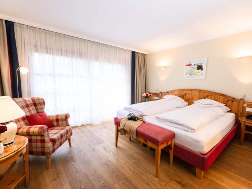 Postel nebo postele na pokoji v ubytování Hotel Kaiserhof Kitzbühel, 4 Sterne Superior