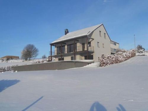 a house in the snow in front at Escape with Bubble Bath in Martilly