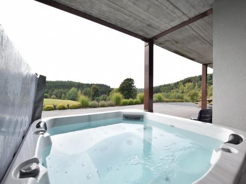 a jacuzzi tub in a house with a view at Escape with Bubble Bath in Martilly