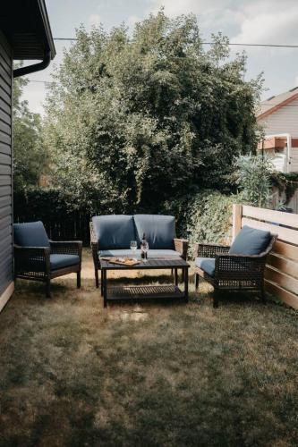 a patio with three chairs and a table with at The Hideout in Barrie
