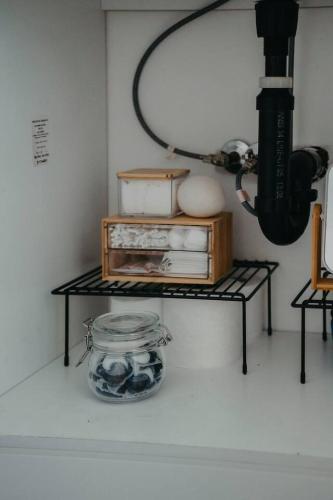 a room with a shelf with a mirror and a table with food at The Hideout in Barrie