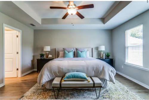 a bedroom with a bed with a ceiling fan at Foley Coastal Escape in Foley