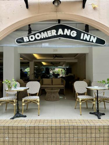 a restaurant with tables and chairs and a sign that reads boomerang inn at Boomerang Inn in Patong Beach