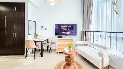 a living room with a couch and a table at Hydra C6 Studio - Luxe View Retreat in Abu Dhabi