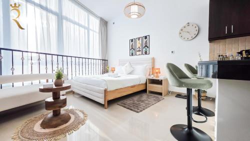 a bedroom with a bed and a table and a chair at Hydra C6 Studio - Luxe View Retreat in Abu Dhabi