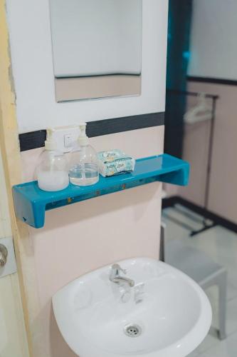a bathroom sink with a blue shelf above it at XX Mitr Inn Phuket Oldtown - มิตรอินน์ ภูเก็ต โอลทาวน์ in Phuket