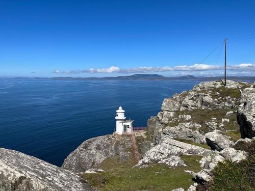 a lighthouse on the edge of a cliff at Ard na Muirí - Durrus - Apartment in Durrus