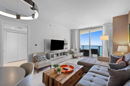 a living room with a couch and a table at Picturesque Beachfront Condo - LOVELY 2BD and 2BA APT WITH DIRECT OCEAN VIEW in Hollywood