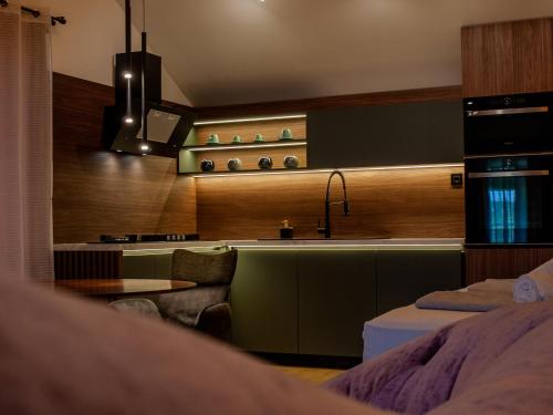 a kitchen with a sink and a table in a room at NOVA LUXURY DESIGN in Zagreb