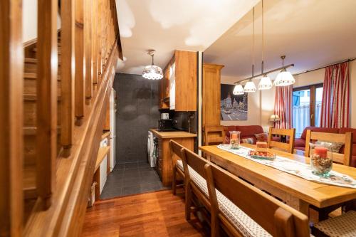 une cuisine et une salle à manger avec une table et des chaises dans l'établissement Casa Rústica - Sorieus Lodge en Lérida, à Bossost