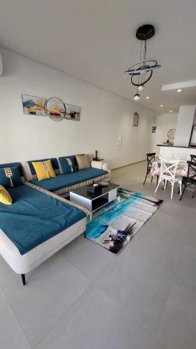 a living room with a couch and a swimming pool at Résidence Blue Bay Monastir Sousse in Monastir