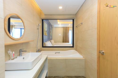 a bathroom with a sink and a mirror at Căn Hộ View Biển FLC Sea Tower Quy Nhơn in Quy Nhon