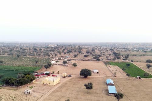 an aerial view of a farm with tents and a field at Osian Camel safari and Village home stay in Gheura