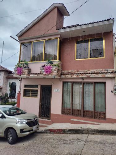 a house with a car parked in front of it at Hospedaje San Francisco.6 personas in Zacatlán