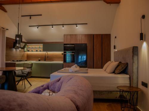 a bedroom with a large bed and a kitchen at NOVA LUXURY DESIGN in Zagreb