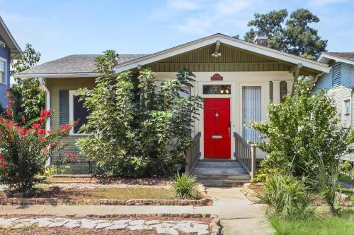 ein Haus mit einer roten Tür und einigen Büschen in der Unterkunft The Nelson House Unbeatable Location in New Orleans