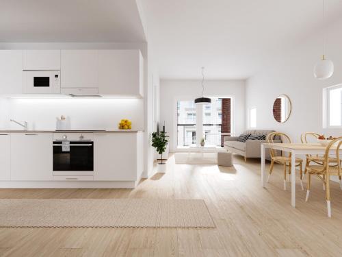 a white kitchen and dining room with a table at Snownest Premium City Centre Apartments 2 in Rovaniemi