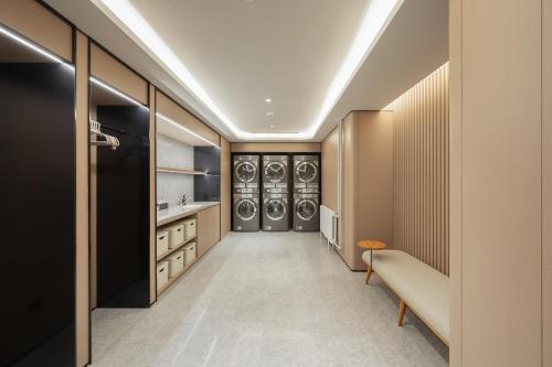 a walk in pantry with a washer and dryer at JI Hotel Beijing Fangzhuang Puhuangyu Subway Station in Beijing