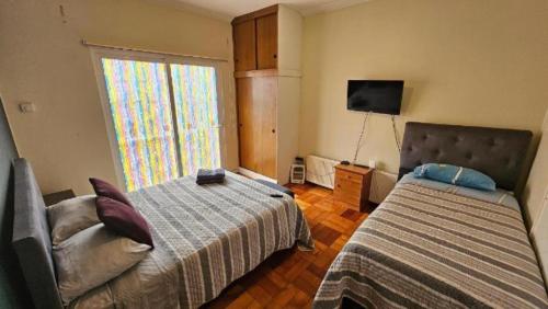 Postel nebo postele na pokoji v ubytování HOSTAL QUINTAMAR 6 Norte 985