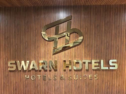 a sign for waars industries and buildings on a wall at Swarn Hotel in Kolkata
