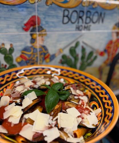 a bowl of food with cheese on top of it at Borbon home central rooms in Palermo