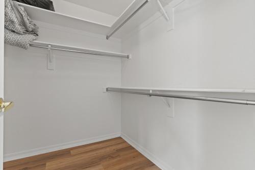 a room with white walls and stainless steel shelves at Pool Oasis 4Br Golf, Ping-Pong, Cornhole Retreat in Glendale
