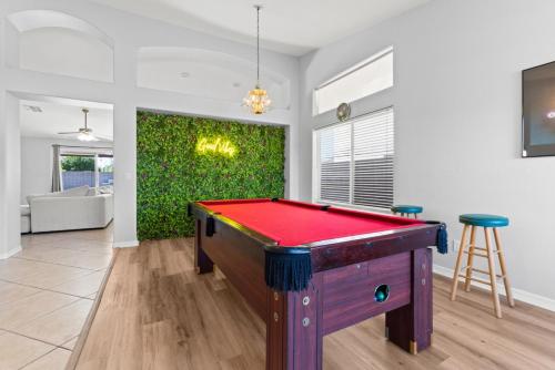 a pool table in the middle of a living room at Pool Oasis 4Br Golf, Ping-Pong, Cornhole Retreat in Glendale