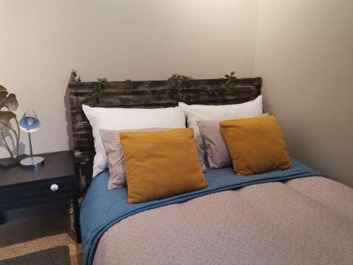 a bed with pillows on it in a room at The Centurion Sunset in Centurion