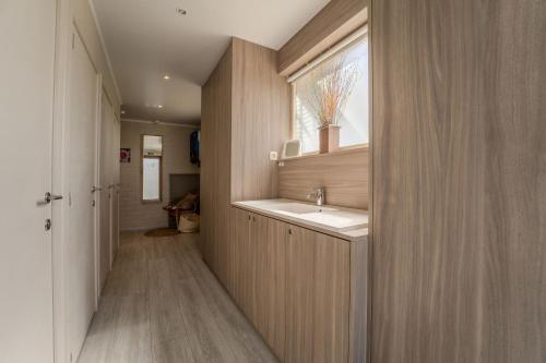 a bathroom with a sink and a window at Hill44 in Zonnebeke