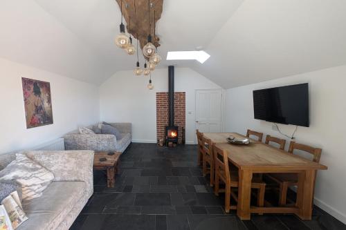 a living room with a couch and a table at Grapnells Lodge, Wallasea Island, Rochford, Essex in Rochford