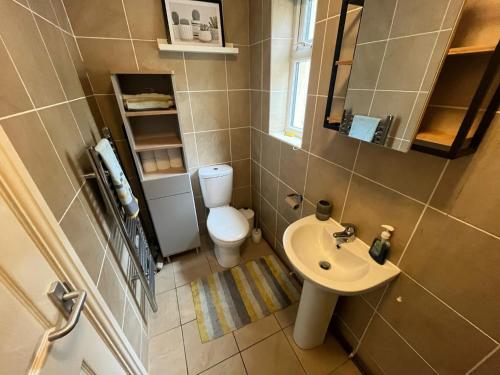 a small bathroom with a sink and a toilet at Sandcastle in Swansea