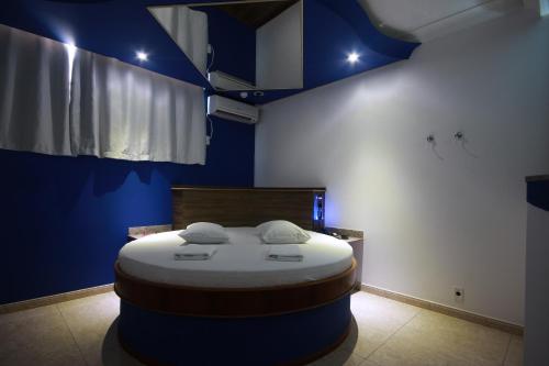 a room with a bed in a blue room at Prime Motel Americana in Americana