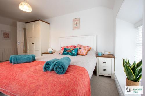 a bedroom with two beds with blue towels on them at The Bird's Nest - Free Parking! in Boscastle