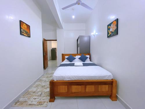 a bedroom with a bed and a ceiling fan at Fairly Suites in Frere Town