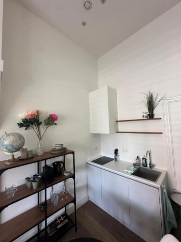 a kitchen with a sink and a counter top at Comfortable City Break Studio in The Hague