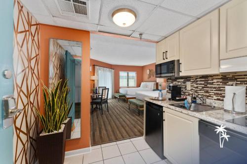 a kitchen and a living room with a bedroom at Boho Chic Garden Condo 7 Min to Universal Parks in Orlando