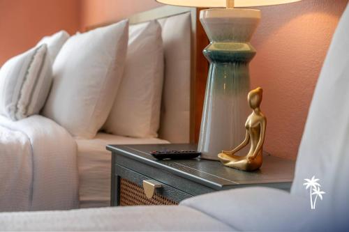 a lamp sitting on a table next to a couch at Boho Chic Garden Condo 7 Min to Universal Parks in Orlando