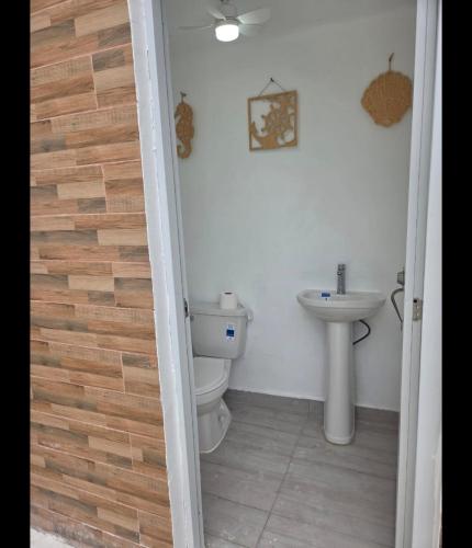a bathroom with a toilet and a sink at Ark Villa in Punta Cana