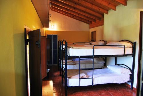 a room with a bunch of bunk beds in it at Albergue Fayacava in Melendreros