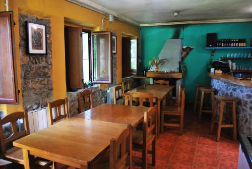 a dining room with wooden tables and chairs at Albergue Fayacava in Melendreros