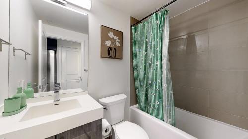 a bathroom with a sink and a toilet and a shower at Cozy 1BR Condo in Core Toronto in Toronto