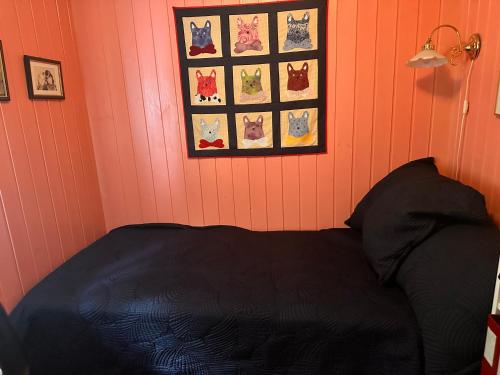 a bedroom with a bed and pictures on the wall at Asleep in the Valley Villa in Oslo