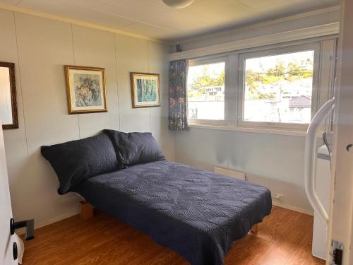 a small bedroom with a bed and a window at Asleep in the Valley Villa in Oslo