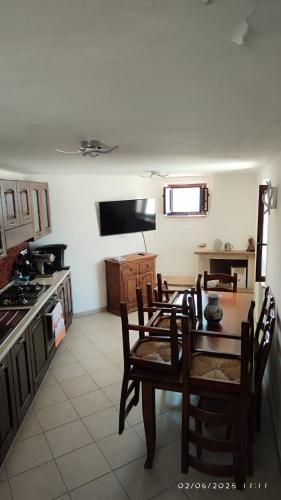 a kitchen with a table and chairs in a room at La Terrazza di Via Roma in Cetraro