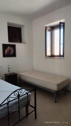 a bedroom with a bed and a window and a mattress at La Terrazza di Via Roma in Cetraro