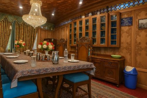 a dining room with a long table and chairs at Crown Of India Group Of Houseboats in Srinagar