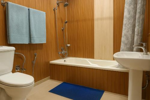 a bathroom with a toilet and a sink and a tub at Crown Of India Group Of Houseboats in Srinagar