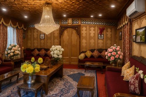 a living room with couches and a chandelier at Crown Of India Group Of Houseboats in Srinagar