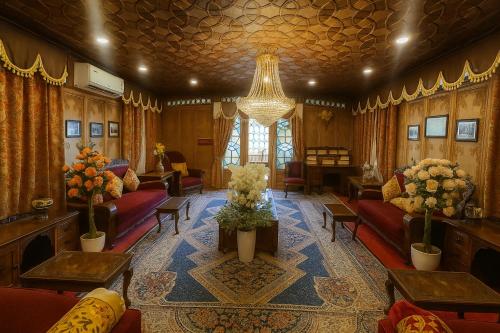 a living room with couches and a chandelier at Crown Of India Group Of Houseboats in Srinagar