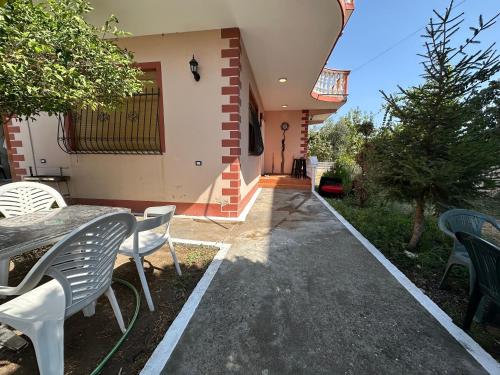a table and chairs in front of a house at THE DOMI Apartments in Durrës
